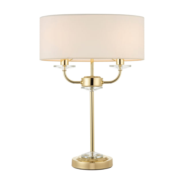 Gallery Direct Ostwyn 2 Light Table Lamp in brass with crystal accents and a vintage white fabric drum shade on a plain white background.