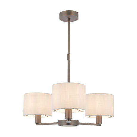 Gallery Direct Delyra 3 Light Ceiling Pendant with cylindrical cream fabric drum shades on antique bronze arms and rod mount, on a white background.
