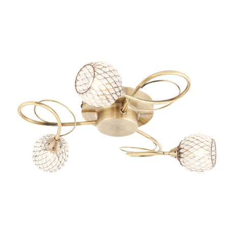 Gallery Direct Arvael 3 light flush ceiling lamp in antique brass with curling scroll arms and clear glass beaded mesh cage shades on a white background.