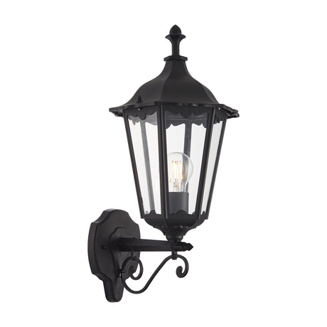 Gallery Direct Burvael black outdoor wall lantern with six-sided glazed head, finial top and scrolled bracket, shown on a white background.