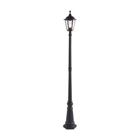 Gallery Direct Burvael outdoor lamp post in matt black with a fluted tapered base and six-sided Victorian lantern with clear glass panels and finial.