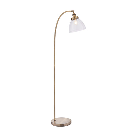 Gallery Direct Sarwen Arched Floor Lamp in antique brass with a curved stem, clear glass dome shade, and weighted round base on a white background.