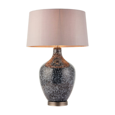 Gallery Direct Ilvenne table lamp with speckled grey, black and copper glass urn base, brushed metal foot and soft grey fabric drum shade on white.
