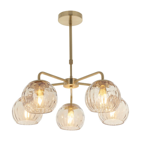 Gallery Direct Ilvaris 5 Light Pendant in brushed brass with five rippled amber glass globes fanning from a central hub on a drop rod.