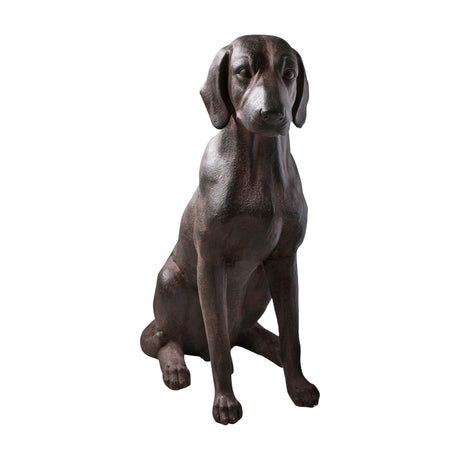 Gallery Direct Digvane Sitting Dog Sculpture in aged bronze resin, modelled as a seated hound with tilted head and poised front legs, on a white background.