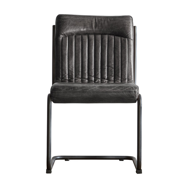Gallery Direct Caprelle Leather Dining Chair in Antique Ebony with channel-stitched back, diamond-stitched seat and black tubular iron cantilever frame.