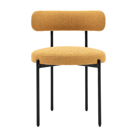 Gallery Direct Avelenne ochre bouclé dining chair with rounded bolster back, padded seat and slim black iron legs, shown on a plain white background.