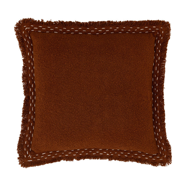 Gallery Direct Harmvane square cushion in rust woven cotton blend with brushed fringe trim and cream hand-stitched contrast border on white.