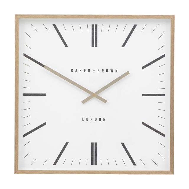 Gallery Direct Penvorne Square Wall Clock with pale oak frame, white dial, black graphic hour markers, slim gold hands, and BAKER + BROWN LONDON lettering.