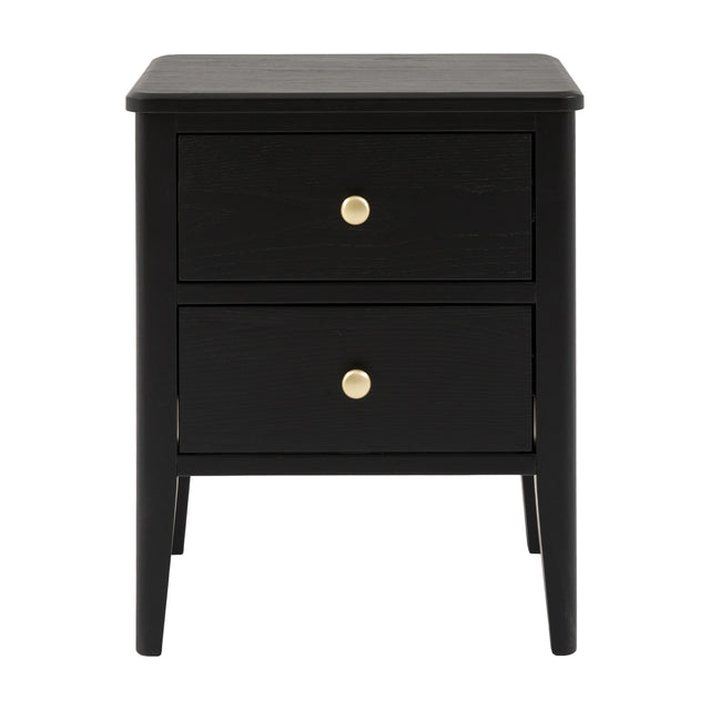 Gallery Direct Actenna black bedside table with two drawers, round brass knobs and turned tapered legs on a plain white background.