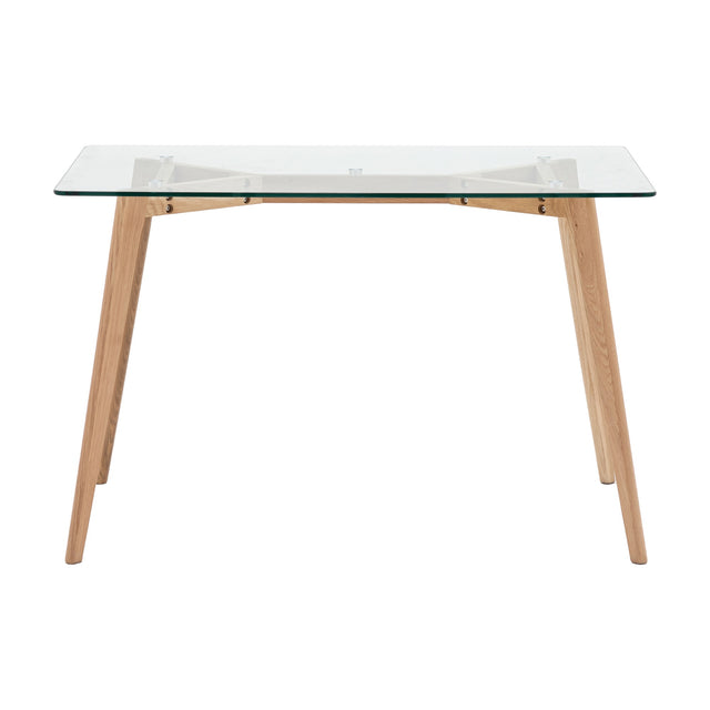 Gallery Direct Blavora Rectangle Dining Table with clear tempered glass top and splayed tapered natural oak legs on a plain white background.