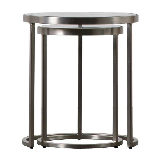 Gallery Direct Rovane Round Nesting Tables Set of 2 with slim silver powder-coated iron frames and clear glass tops on a plain white background.