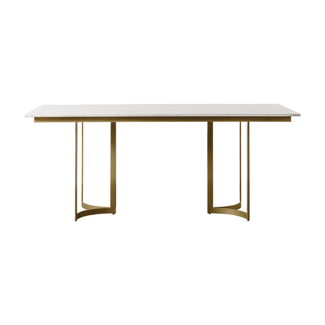 Gallery Direct Evervane Dining Table with pale honed stone top and twin curved gold powder-coated iron supports on a plain white background.