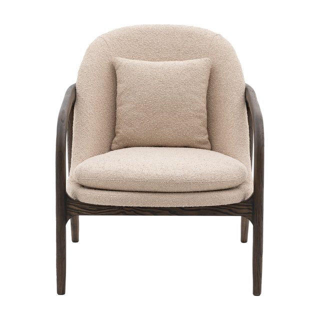 Gallery Direct Alevane Bouclé Armchair in taupe with curved brown oak frame, deep seat pad and square scatter cushion on a white background.
