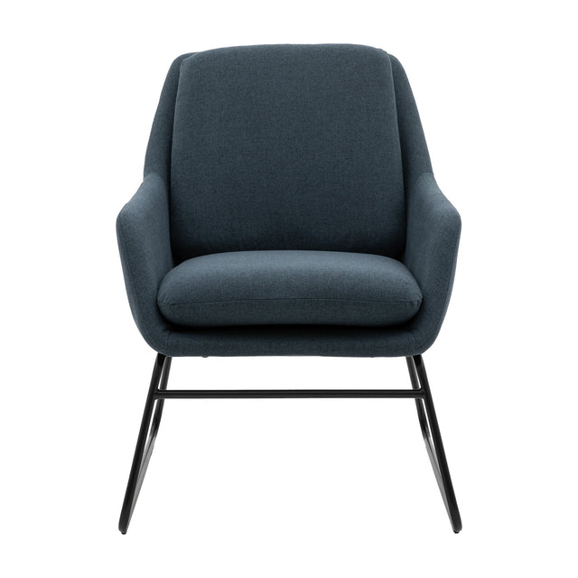 Gallery Direct Funvorne fabric accent chair in midnight blue with curved padded back, wide seat, and black iron crossed sled legs on a white background.