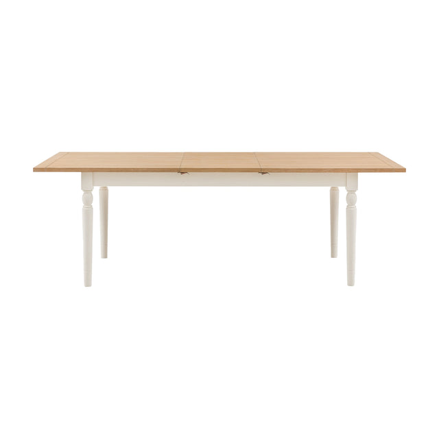 Gallery Direct Etvorne Extending Dining Table with natural oak top, butterfly leaf and turned cream legs, shown on a plain white background.