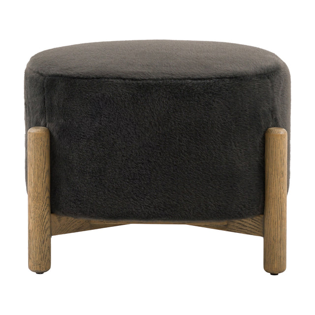 Gallery Direct Tinvane Upholstered Footstool in graphite faux fur with a rounded top and solid oak legs joined by a low cross rail, on a white background.