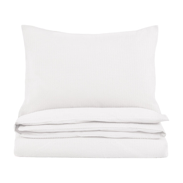 Gallery Direct Mirvane Jacquard Quilt Cover Set in white, folded with a matching waffle-weave pillow on a plain white background.