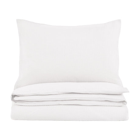 Gallery Direct Mirvane Jacquard Quilt Cover Set in white, folded with a matching waffle-weave pillow on a plain white background.