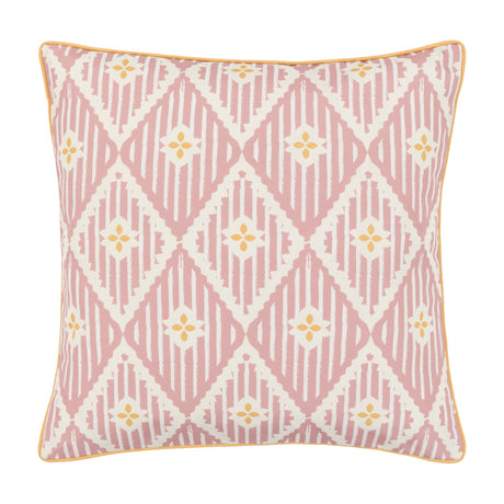 Gallery Direct Oasvane Filled Cushion in pink with a printed diamond lattice, yellow four-petal motifs and contrast piped edge on a white background.