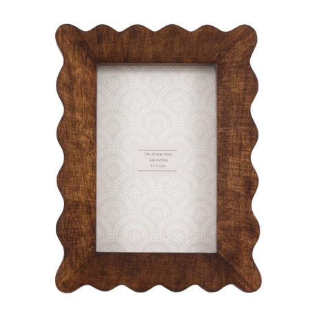 Gallery Direct Avlenne wooden scallop photo frame in brown with wavy carved border and glass front, holding a portrait 4x6in print, on a white background.