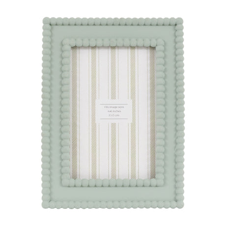 Gallery Direct Covane sage green resin photo frame with double beaded border, portrait 4x6in aperture, freestanding on a plain white background.