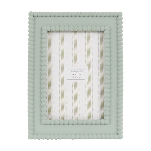 Gallery Direct Covane sage green resin photo frame with double beaded border, portrait 4x6in aperture, freestanding on a plain white background.