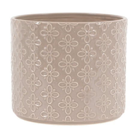 Gallery Direct Selvane Embossed Ceramic Planter in warm grey, a round cylindrical pot with glossy glazed four-petal floral motif, on a plain background.