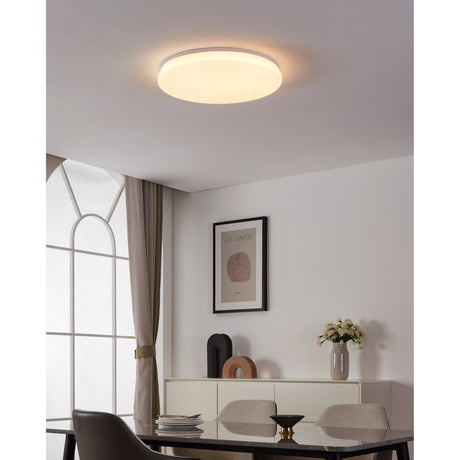 Galmane Smart Crystal Effect LED Flush Ceiling Light 53cm in white, illuminated on a dining room ceiling with warm glow, above a table and sideboard decor.