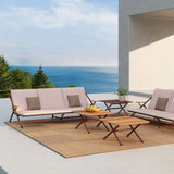 Garda 3 Seater Garden Sofa Cushion Set in pink fabric with brown accent cushions, fitted to a rust-finish aluminium frame sofa on an outdoor patio with sea view.
