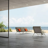 Garda 3 Seater Garden Sofa Cushion Set in grey fabric with orange accent cushions, fitted on an aluminium sofa frame in a beachside outdoor setting.