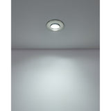 Gedrez round LED downlight in satin nickel finish, recessed in a white ceiling and shown illuminated, casting light onto the wall below.