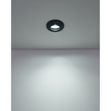 Recessed round LED downlight from the Gedrez set in black plastic, mounted flush in a ceiling and casting a cool white beam downward onto a plain wall.