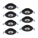 Set of 7 black Gedrez LED downlights, round recessed fixtures with tiltable inner rings and clear plastic shades over integrated LEDs, shown with blue spring clips.