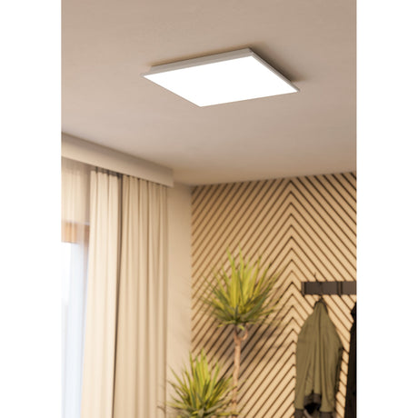 Gevette Smart LED Panel Light, a square 45 x 45cm white ceiling panel with slim frame, mounted flush on a bedroom ceiling above curtains and patterned wall panelling.