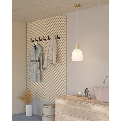 Girbena Glass Pendant Light with rounded opal glass shade, brushed brass canopy and cord sleeve, shown above a wooden dresser in a hallway setting.