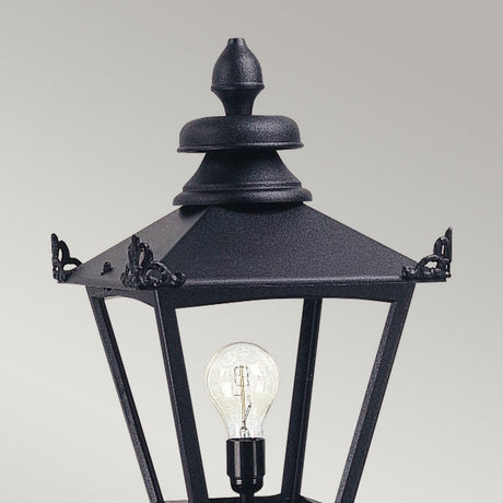 A close-up of the Grampian 1 Light Lamp Head in black, showcasing its Victorian-style design crafted from cast aluminum. The lamp features a glass pane that reveals a visible light bulb inside, set against a plain light gray background.