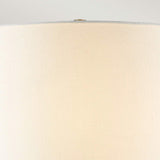 Close-up of the Arabella 1 Light Table Lamp in gold, showcasing its ivory shade against a neutral background. The textured fabric and cylindrical shape are highlighted, with a subtle view of the lampshade's top edge.