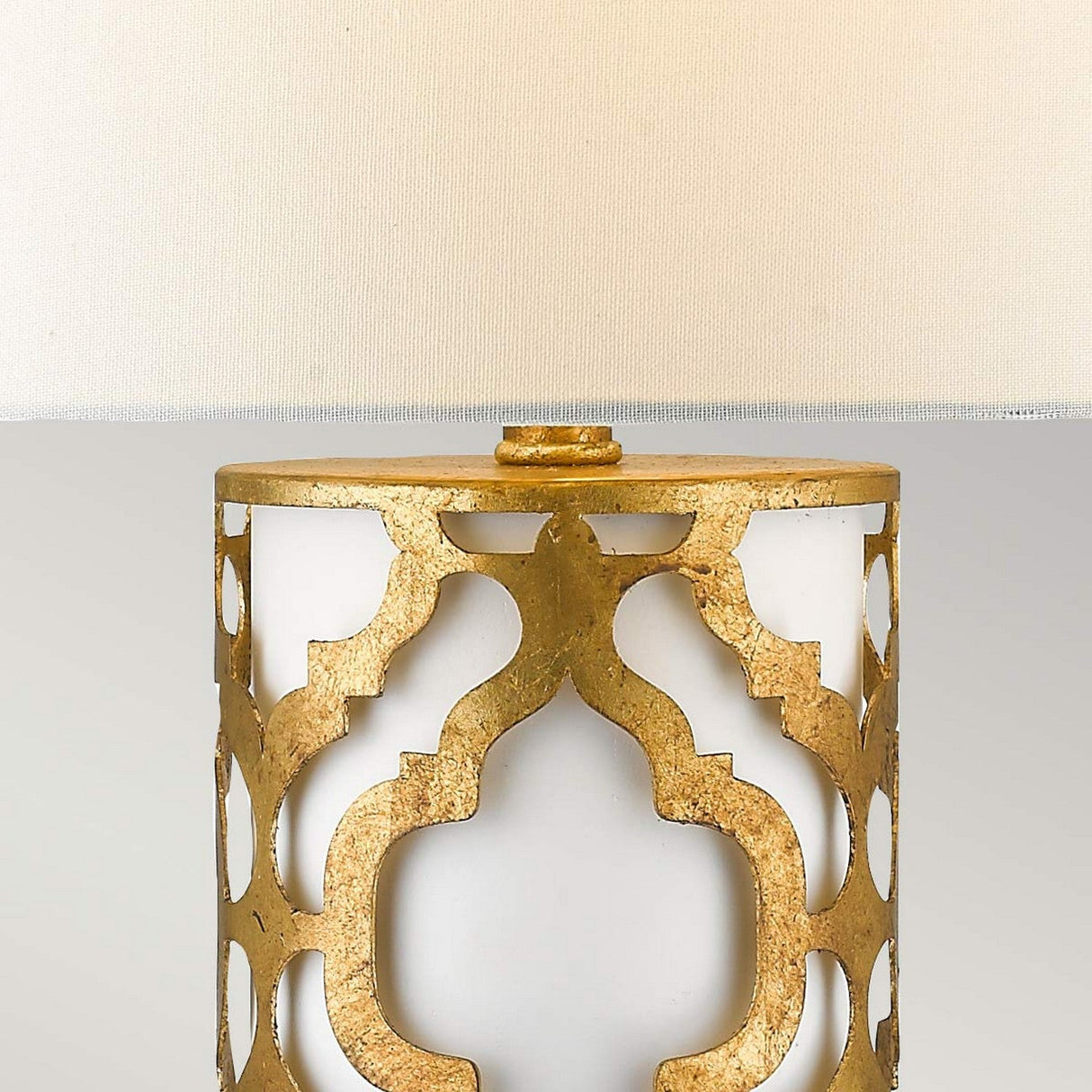 Close-up of the Arabella 1 Light Table Lamp, featuring an ivory shade. The base showcases a detailed gold geometric pattern on a white background, exuding a luxurious and elegant design.