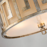 A close-up of the Lemuria 3 Light Duo-Mount Large Pendant/Semi-Flush in Gold with an Ivory Shade showcases its elegant metallic frame adorned with a Grecian key motif. The warm glow accentuates the intricate design details, creating a sophisticated ambiance, while adjustable rods ensure perfect placement.