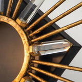 Close-up of the Sun King 1 Light Wall - Gold Leaf, featuring a decorative round center bordered by gold-leaf spokes. Each spoke is adorned with K9 cut glass crystals at the tips, evoking rays of sunlight. The design exudes modern elegance against a plain backdrop.