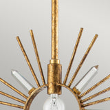 Close-up of the Sun King 1 Light Pendant in Gold Leaf, showcasing a central light bulb encased by a decorative circular frame in a starburst design. Radiating metal rods and crystal prisms extend outward, forming an adjustable pendant light against a soft grey background.