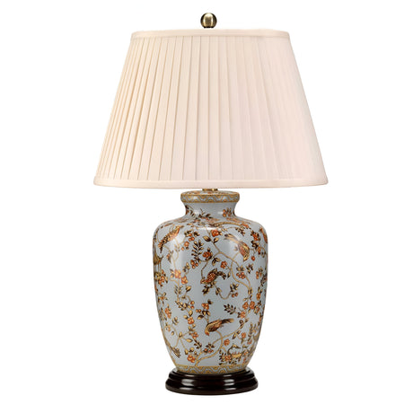 The Gold Birds 1 Light Table Lamp features a light blue Chinese porcelain base with a delicate gold finish, adorned in pastel floral patterns. It is paired with a pleated cream lampshade and rests on a dark circular stand, adding an elegant touch to any room.