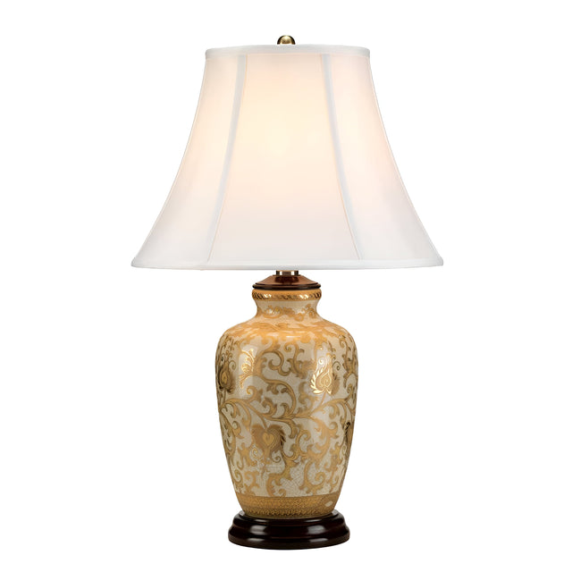 The Gold Thistle 1 Light Table Lamp - Gold includes a decorative beige ceramic base adorned with an intricate gold floral pattern. It features an elegant white fabric lampshade and rests on a dark circular base, producing a warm glow.