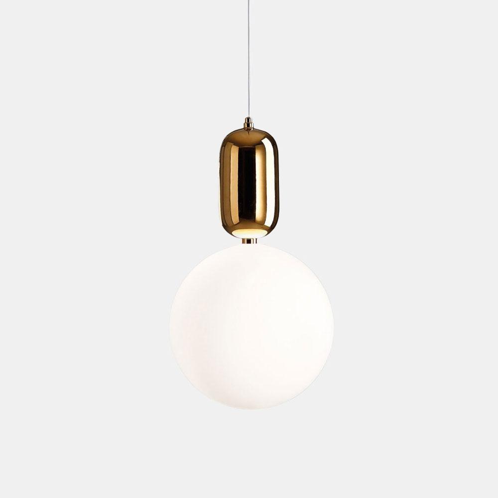 The Pallo Pendant Light - Gold exudes sophistication with its round opal glass diffuser and eye-catching gold finish, elegantly suspended by a slim cord against a simple gray backdrop.