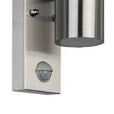 Close-up of the Gorbora outdoor wall light in brushed stainless steel, showing the cylindrical glass-shaded head, fixing screws, and built-in motion sensor on the rectangular backplate.