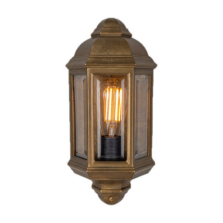 Gosella Half Lantern Wall Light in Antique Brass with domed hexagonal roof, bevelled glass panels and visible E27 bulb, shown on a plain white background.