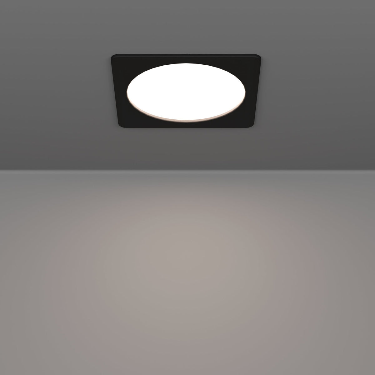 Gosmelle LED downlight with square black plastic trim and round white diffuser, recessed in a grey ceiling, illuminating the space below.