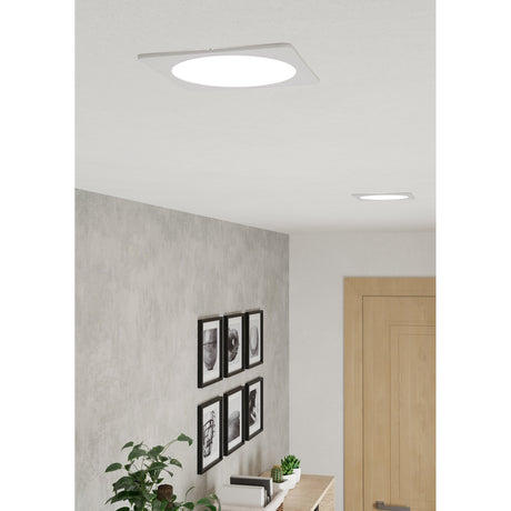 Gosmelle LED Downlight 10.5W 16.6cm in White shown recessed into a hallway ceiling, with a round opal diffuser set within a slim square white trim.