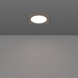 Gosmelle LED Downlight, 11.7 x 11.7cm, recessed into a grey ceiling, square satin nickel bezel framing a round white diffuser, illuminated and shown above a plain grey interior.